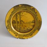 A Doulton Burslem Yellow/Ochre ground Plate, black printed  with a rural scene and a church.   Date: