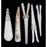 A Victorian carved and inlaid whale bone shoe horn, decorated with Ships, whale and volcano, the