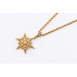 An Edwardian yellow gold pearl set star pendant, approx 15mm,  suspended on a yellow metal Prince of
