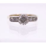 An early 20th Century diamond set 18ct ring, comprising a central round brilliant cut approx 0.60ct,