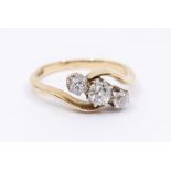 A three stone diamond and 18ct gold ring, comprising three graduated old cut diamonds, total diamond