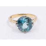 A blue zircon and 18ct gold solitaire, comprising a round cut zircon claw set to a patterned 18ct