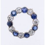 An early 20th century sapphire and diamond circular gold brooch, open form comprising alternate