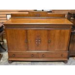 A large oak early 20th Century sideboard, with two cupboard doors above three single drawers, detail