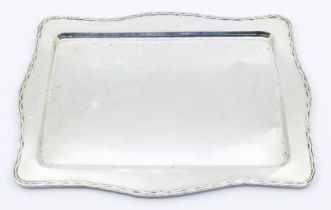 A George V silver dressing table tray, wavy rim, hallmarked by William Griffiths & Sons, Birmingham,