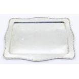 A George V silver dressing table tray, wavy rim, hallmarked by William Griffiths & Sons, Birmingham,