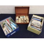 A small wooden box containing cigarette cards plus 2 shoe boxes containing postcards.