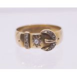 An early 20th century diamond and 18ct gold set buckle ring, width approx 6mm, size O, total gross