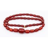 A cherry amber Bakelite type graduated bead necklace, comprising ovoid breads measuring approx 25