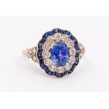 An Art Deco sapphire and diamond style 18ct gold ring, comprising a claw set central oval mixed