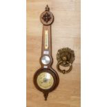 A Weathermaster barometer; a brass lion mask door knocker (2)