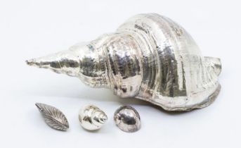 A collection of silver four various electro plated shells including large conch shell, small sea