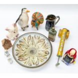 A collection of early 20th Century figures, gift ship items, money boxes, vintage tins, glass wares,