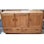 Two Ercol sideboards - one three over two, the other having side cupboard plus two further doors