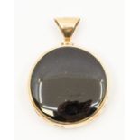A  9ct gold snowflake obsidian and black goldstone reversible pendant, round shaped form with