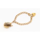 A 9ct gold link bracelet with padlock clasp, length approx 17cm, suspending a 9ct gold and smoky
