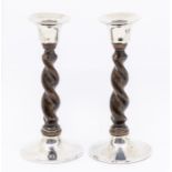 A pair of Arts & Crafts silver mounted oak barley twist candlesticks with plain mounts and