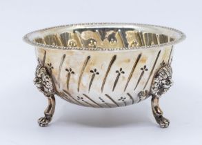 A Georgian style silver sugar bowl, wyvern decoration, on three lion's paw feet, hallmarked by D & J