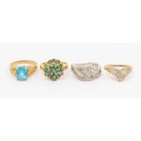 A collection of four 9ct gold dress rings to include a blue topaz solitaire, size N, along with a