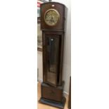 A German dwarf or grandmother clock with 7" dial, Arabic numerals. Contained in oak case. 170cms x