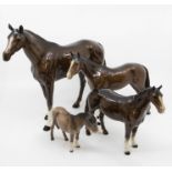 Four John Beswick animal figures including a large horse, with two smaller horses, along with a