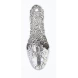 An Edwardian silver shoe shaped wall posy holder, the body and front profusely chased with scrolls
