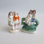 Two Staffordshire miniature figures, one of children sitting on a tree stump the other standing
