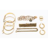 A large collection of 9ct gold jewellery to include three hinged baby bangles, a wider machine