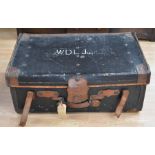 Two early 20th Century travel trunks, one black leather, one hard board