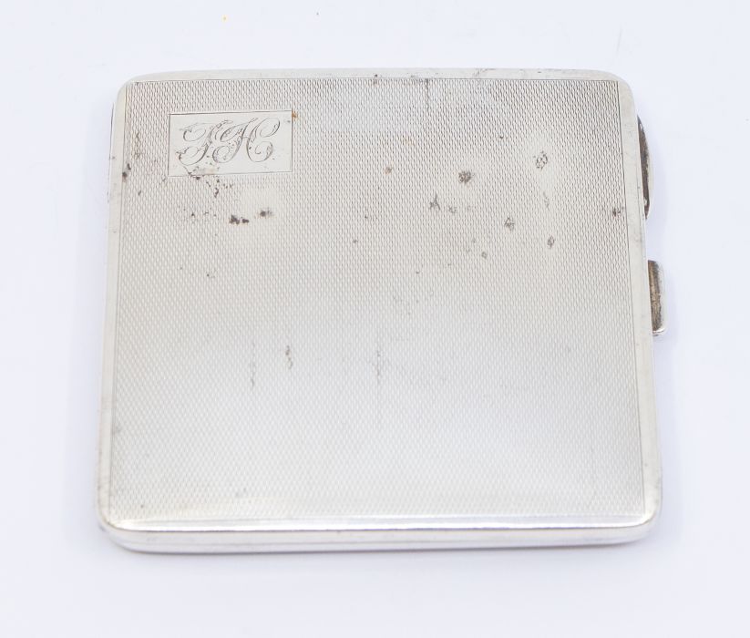 A George VI silver engine turned cigarette case, engraved with initials, hallmarked by W Neale,