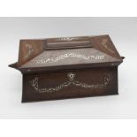 A Victorian inlaid rosewood and mother-of-pearl sarcophagus shaped tea caddy and cover, fitted