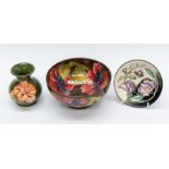 Moorcroft Pottery; a brown ground Hibiscus bowl; a green ground Hibiscus vase and a boxed Trailing