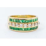 An emerald and white stone three row 14ct gold ring, comprising a single row of French cut white