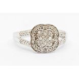 A diamond and white metal ring, floral setting with split shoulders, size L1/2, total gross weight
