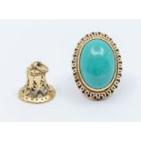A large turquoise and gold ring, comprising an oval turquoise approx 25 x 20mm, rub over set