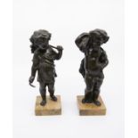 A pair of 20th Century bronze putti on marble bases, height 21cm