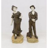 A pair of early 20th century Austrian Figures of a man holding a spade, the woman scattering