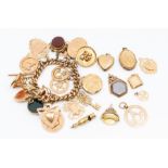 A rose metal charm bracelet, with padlock clasp, suspending 17 various 9ct gold and yellow metal