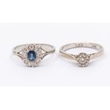 A sapphire and diamond cluster platinum  ring, comprising an oval cut sapphire within a border of