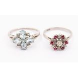 An ruby and diamond set floral cluster 18ct white gold ring, the centre set with a round brilliant