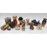 A collection of vintage and novelty money boxes including ceramic, treen, metal and tin examples