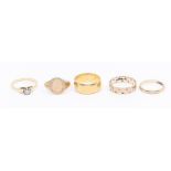 A collection of five gold rings to include a wide 22ct gold band, size O1/2, weight approx 8gms a