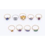 A collection of eight 9ct gold and gem set rings to include gem set rings, including a sapphire