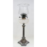 An early 20th Century plated oil lamp, fluted column stand of tripod support, stamped Walker &