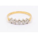 A diamond and 18ct five stone half eternity ring, claw set with seven round brilliant cut, total