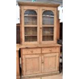 Antique pine glazed kitchen dresser, three inner shelves behind two glazed doors, above two single