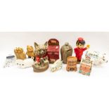 A collection of mixed ceramic wood and tin mid to late 20th Century money boxes including Wade