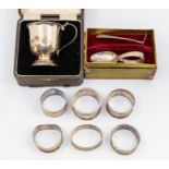 A collection of silver to include: six various napkin rings, a cased Christening cup and a Child's