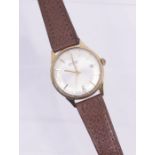 Garrard- a gents automatic 9ct gold wristwatch, round silvered dial with applied gold tone baton and