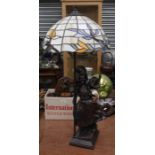 A reproduction Tiffany style table lamp with an Edwardian lady figure to stand